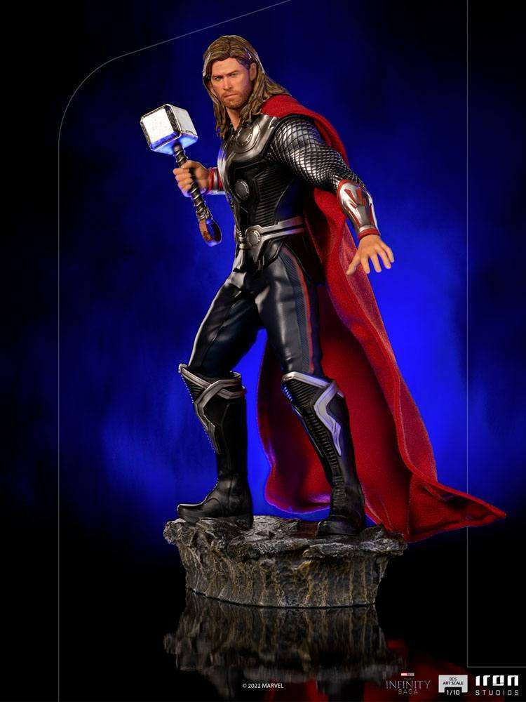 Iron Studios 1/10 Thor Battle of NY statue featuring a glowing Mjolnir, red cape, and detailed armor on a rocky base.