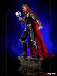 Iron Studios 1/10 Thor Battle of NY statue featuring a glowing Mjolnir, red cape, and detailed armor on a rocky base.