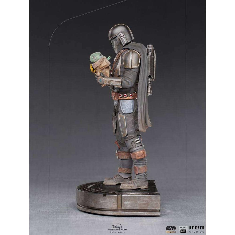 Side view of Iron Studios 1/10 Mandalorian and Grogu statue featuring detailed metallic armor and a grey cape.
