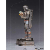 Side view of Iron Studios 1/10 Mandalorian and Grogu statue featuring detailed metallic armor and a grey cape.