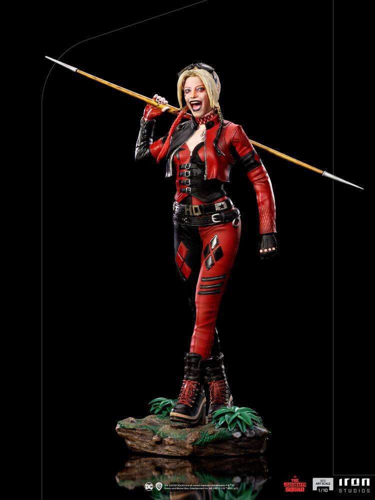 Iron Studios 1/10 Harley Quinn statue from The Suicide Squad, featuring her in a red and black outfit with a spear.