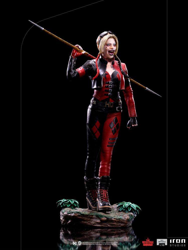 Iron Studios 1/10 Harley Quinn statue from The Suicide Squad, featuring her in a red and black outfit with a spear.