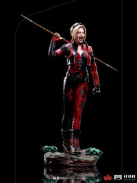 Iron Studios 1/10 Harley Quinn statue from The Suicide Squad, featuring her in a red and black outfit with a spear.