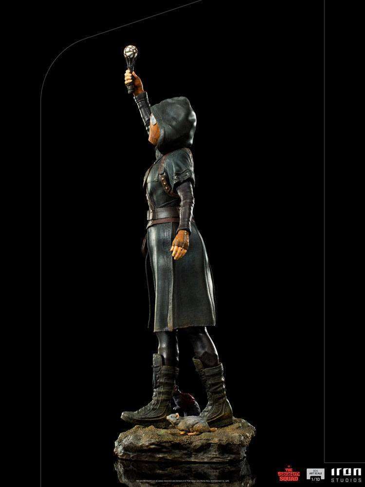 Side view of Iron Studios Ratcatcher II 1/10 scale statue wearing a dark hooded coat and holding a glowing device.