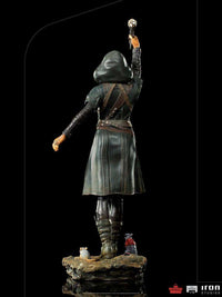 Back view of Iron Studios Ratcatcher II 1/10 scale statue in a dark hooded coat, holding a glowing staff with two rats.