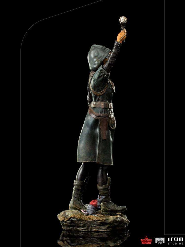 Side view of Iron Studios Ratcatcher II 1/10 scale statue wearing a dark hooded coat and holding a glowing device.