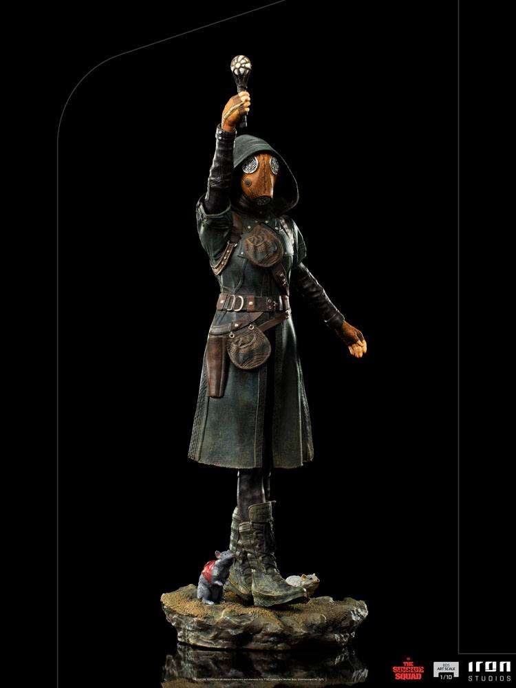 Iron Studios Ratcatcher II 1/10 scale statue in a dark coat and gas mask, holding a glowing device on a rocky base.