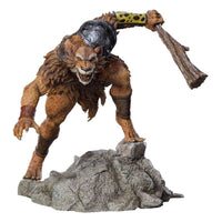 Iron Studios Jackalman 1/10 scale statue in a dynamic crouching pose, wielding a wooden club on a rocky base.