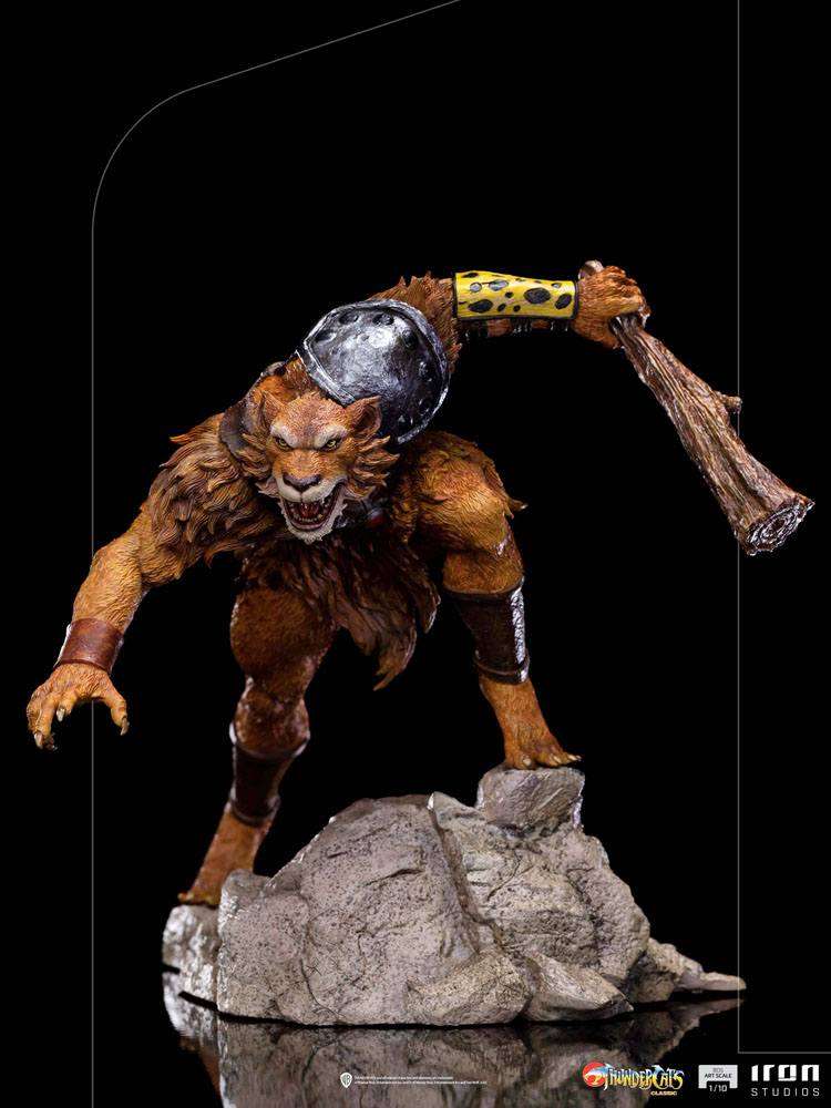 Iron Studios Jackalman 1/10 scale statue in a dynamic crouching pose, holding a wooden club on a rocky base.