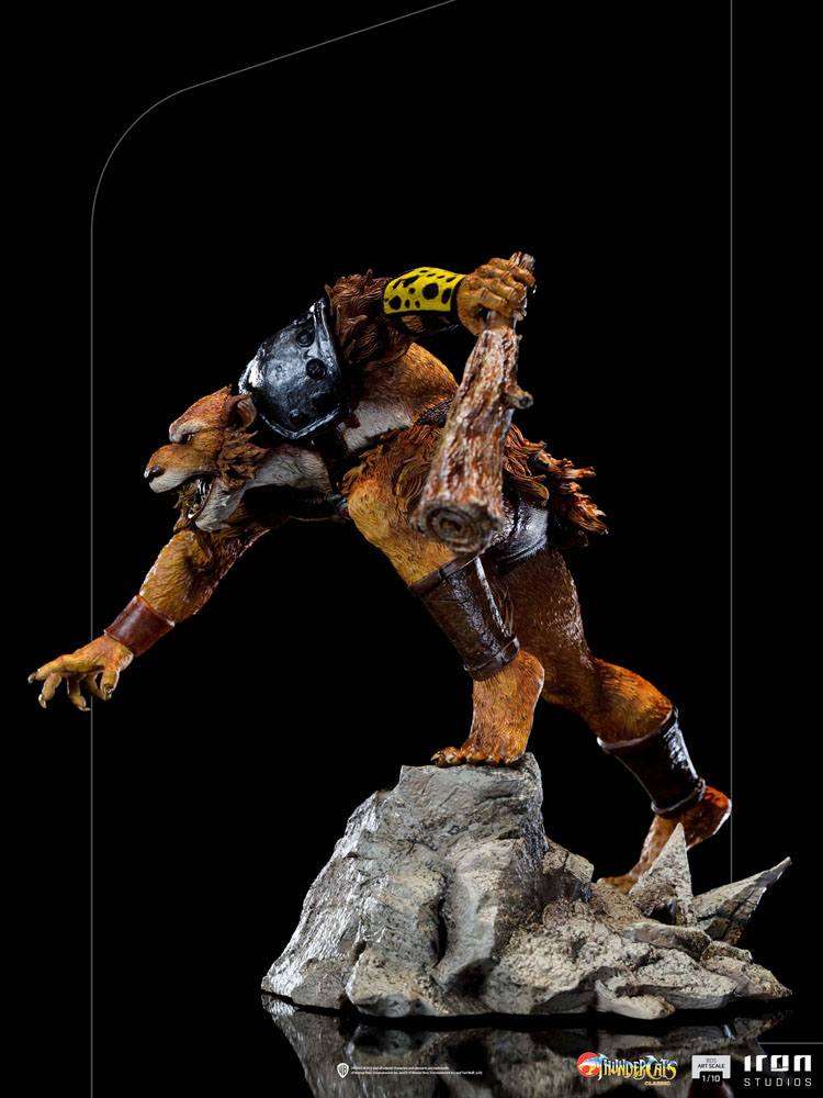 Side view of Iron Studios Jackalman 1/10 scale statue, featuring a snarling, furred figure holding a wooden club.