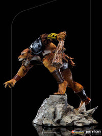 Side view of Iron Studios Jackalman 1/10 scale statue, featuring a snarling, furred figure holding a wooden club.