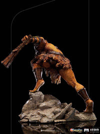 Back view of Iron Studios Jackalman 1/10 scale statue, featuring detailed fur texture and a club on a rocky base.