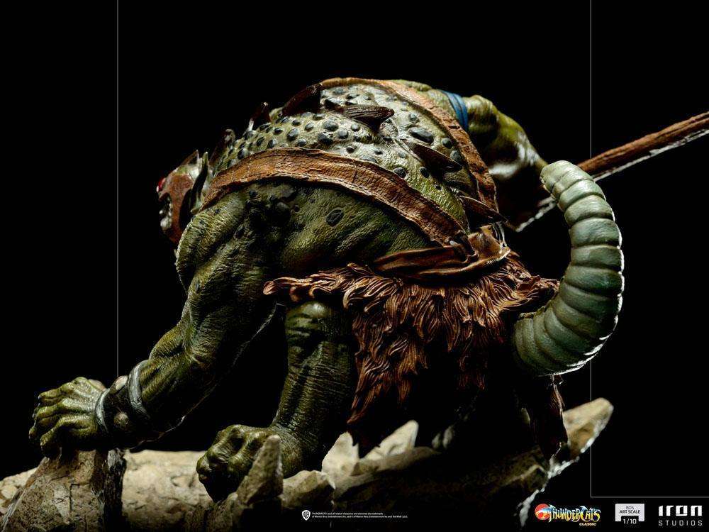 Side view of Iron Studios Slithe 1/10 scale statue, featuring detailed green reptilian skin and a fur loincloth.