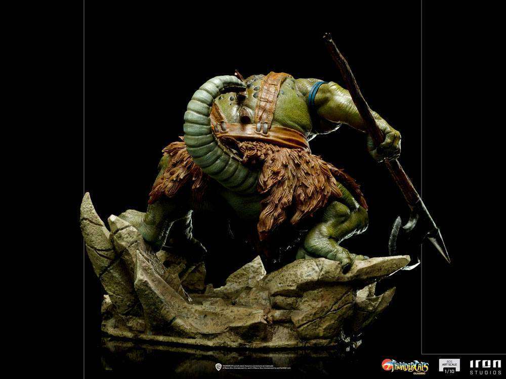 Back view of Iron Studios Slithe 1/10 scale statue, showing green reptilian skin, fur loincloth, and battle axe on rock.