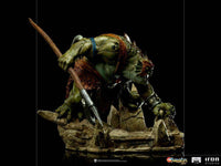 Side view of the 17 cm Iron Studios Slithe BDS Art Scale statue, featuring the green reptilian warrior with a spear.