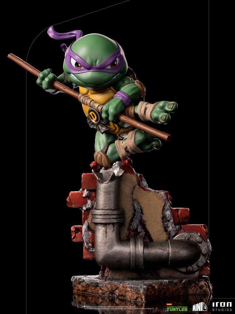 Iron Studios Donatello Mini Co. PVC figure in a dynamic pose with his bo staff atop a brick and pipe base.