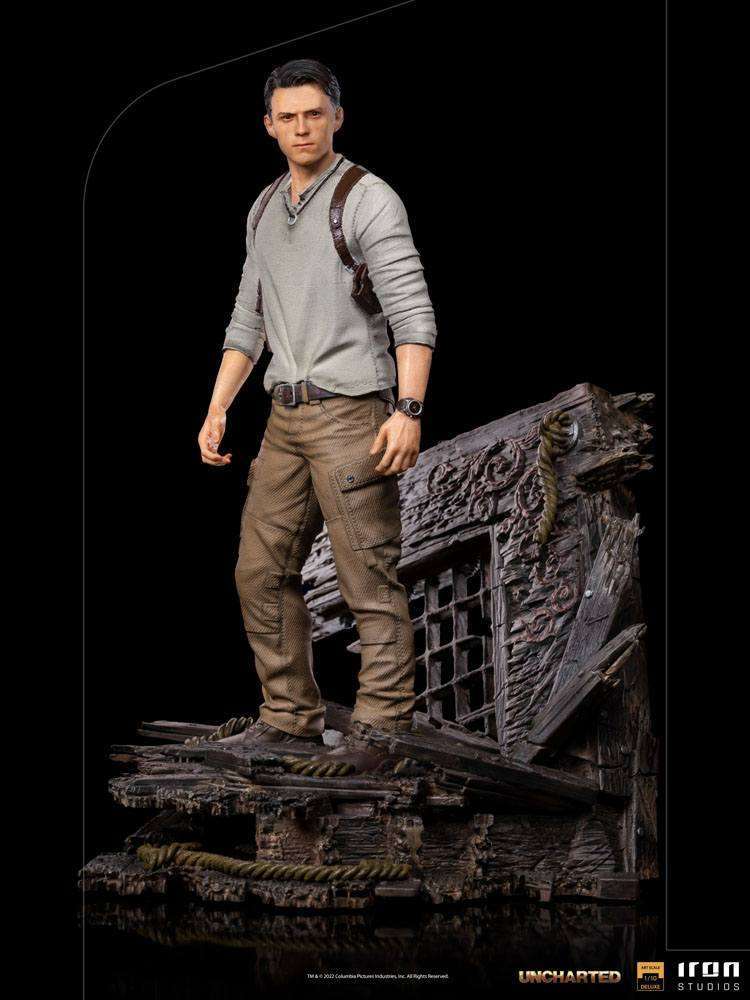 Iron Studios 1/10 Nathan Drake statue from the Uncharted movie, featuring a detailed figure on a ruined wooden base.