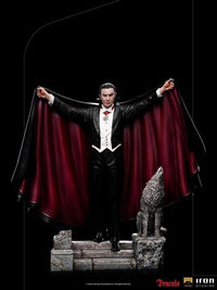 Iron Studios 1/10 Dracula Deluxe statue featuring the vampire in a black tuxedo and red-lined cape with a wolf on stone steps.