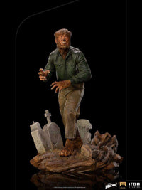 Iron Studios The Wolf Man 1/10 scale statue in a green shirt and brown pants standing on a detailed graveyard base.
