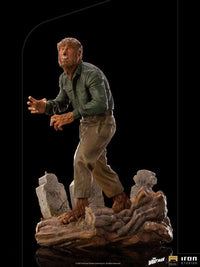 Iron Studios 1/10 The Wolf Man deluxe statue in a side view, featuring the werewolf standing on a graveyard base.