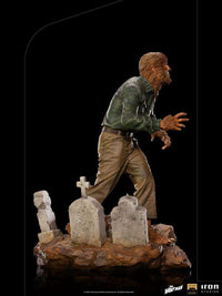 Side view of Iron Studios The Wolf Man 1/10 scale statue featuring the hairy monster standing in a graveyard.
