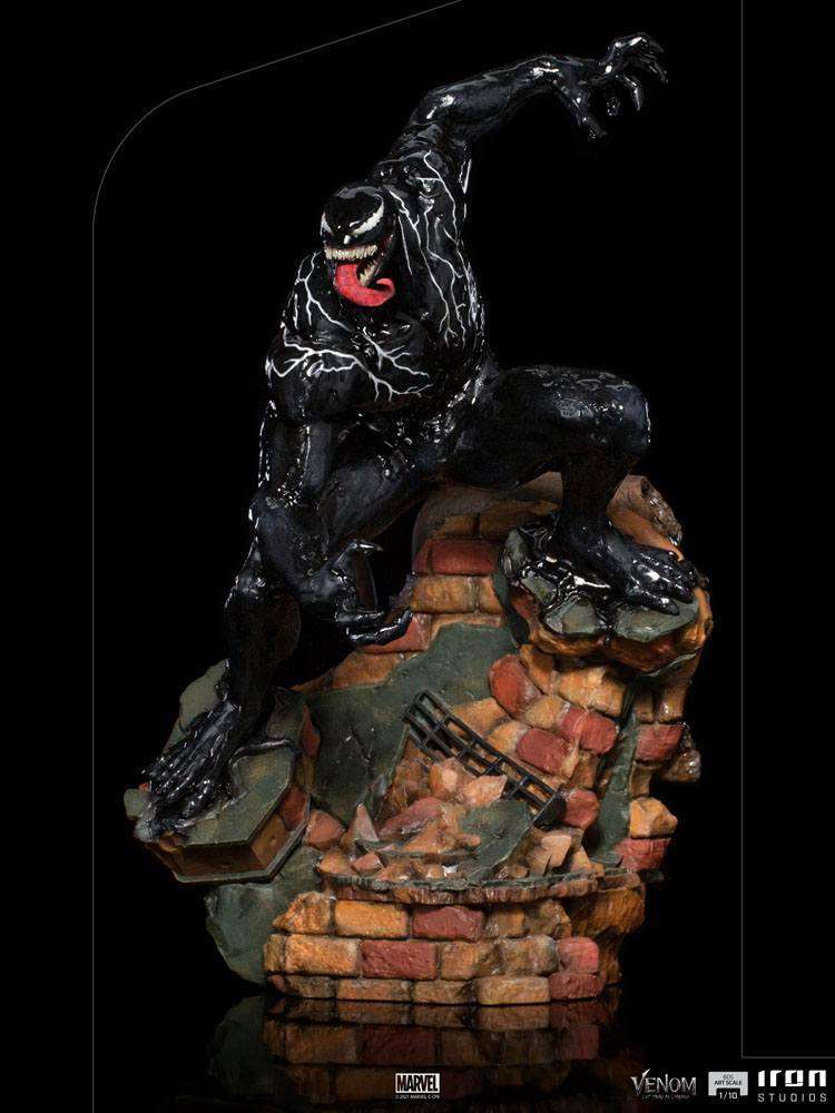 Iron Studios 1/10 scale Venom statue featuring a glossy black symbiote figure posed on a detailed brick rubble base.