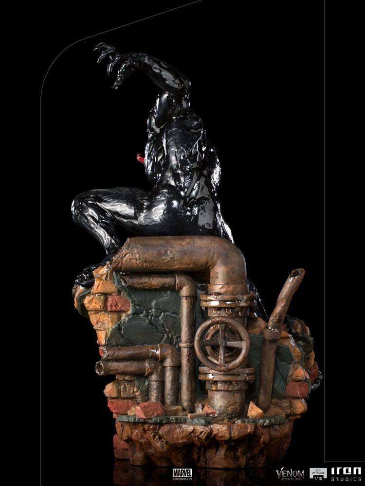 Back view of Iron Studios Venom 1/10 scale statue, featuring a glossy black symbiote perched on a rusted pipe base.