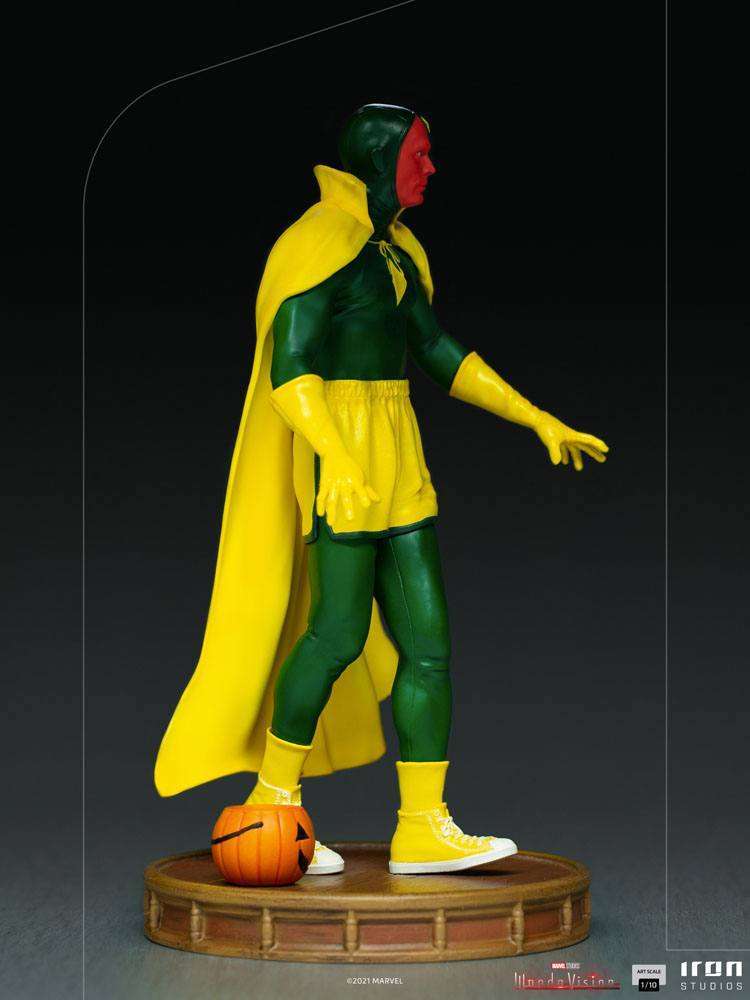 Side view of Iron Studios WandaVision Vision Halloween 1/10 scale statue in a green and yellow costume with a pumpkin.