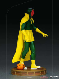 Side view of Iron Studios WandaVision Vision Halloween 1/10 scale statue in a green and yellow costume with a pumpkin.