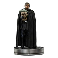 Iron Studios 1/10 scale Luke Skywalker and Grogu statue in a black cloak, standing on a circular metallic base.