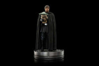 Iron Studios 1/10 scale Luke Skywalker and Grogu statue in a black cloak, standing on a circular metallic base.