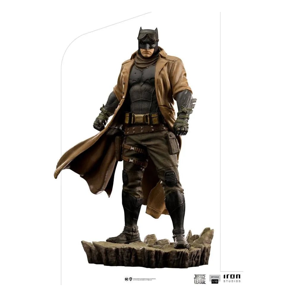 Front view of Iron Studios Knightmare Batman 1/10 scale statue wearing a tan trench coat on a rocky base.