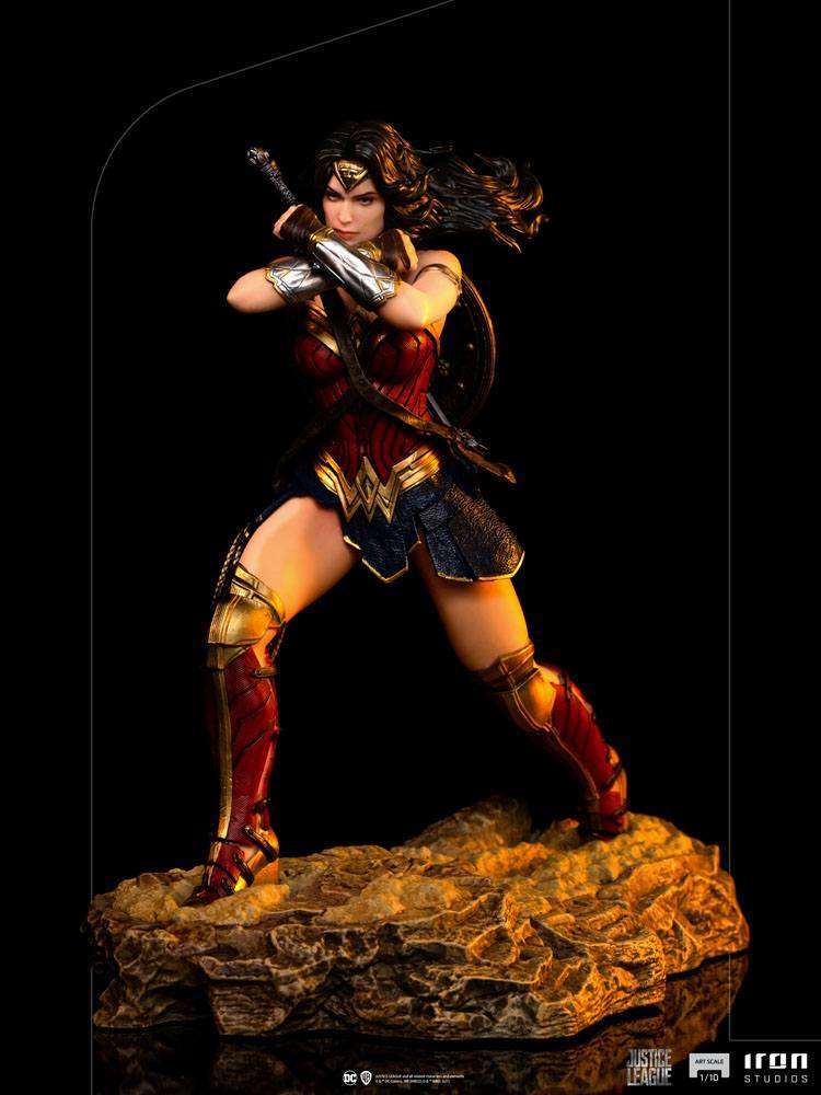 Iron Studios 1/10 Wonder Woman statue from Justice League in a dynamic combat pose on a rocky base.