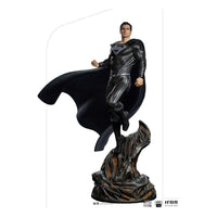Iron Studios 1/4 scale Superman Black Suit statue from Justice League, featuring a flowing cape on a rocky base.