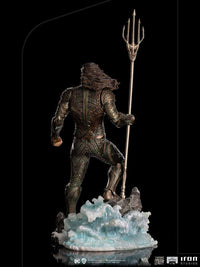 Back view of Iron Studios 1/10 scale Aquaman statue holding a trident, standing on a translucent water base.