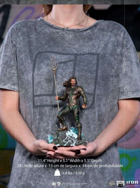 Iron Studios 1/10 scale Aquaman statue from Justice League, held in hands, featuring detailed armor and trident base.