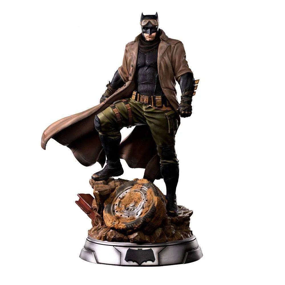 Iron Studios 1/4 Batman Knightmare statue from Justice League, featuring a brown trench coat on a desert rubble base.