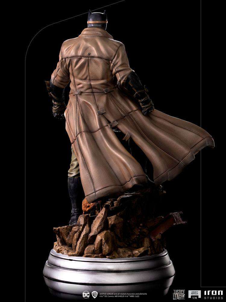 Back view of Iron Studios 1/4 scale Batman Knightmare statue wearing a textured brown trench coat on a rubble base.