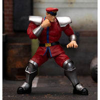 Jada Street Fighter M. Bison 1/12 scale action figure in a dynamic combat pose wearing his signature red military uniform.