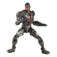 McFarlane DC Justice League Cyborg 18 cm action figure in a dynamic combat pose with metallic silver armor and blue light.