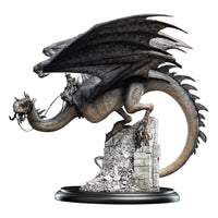 Side view of Weta Workshop Fell Beast mini statue, featuring a detailed grey dragon perched on stone ruins.