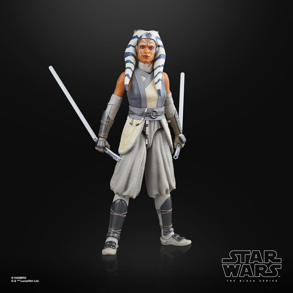 Star Wars action figure of Ahsoka Tano holding lightsabers on a black background